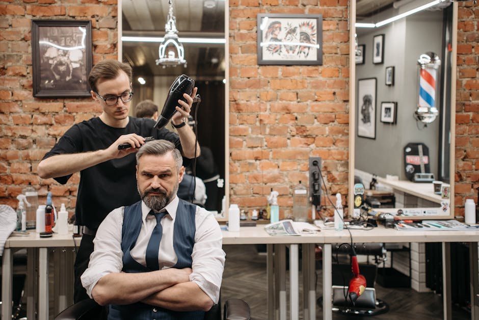 Professional barber cutting hair with precision in modern barbershop
